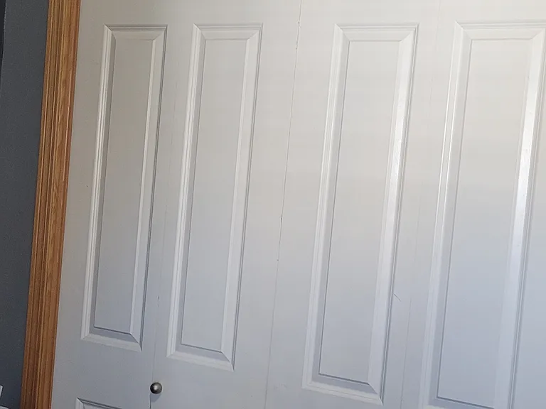 Bedroom closet and ledge with storage bins.