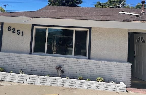Modern, white exterior with dark navy trim....and a new roof getting installed in the next week!