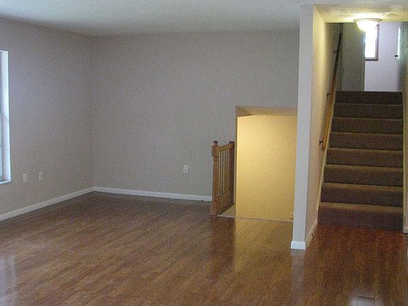 Living Room leading to foyer and stairs to upper level