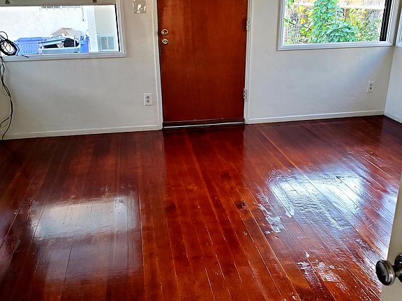 View from Kitchen looking at front door and refinished hardwood floors.