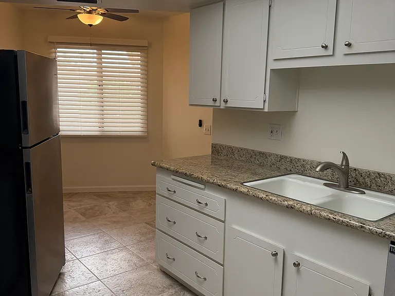 Kitchen with eat in area in back.