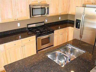 Slab granite counters and extra deep sink make this kitchen a pleasure to use