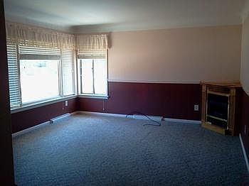 The living room has a nice fireplace and plenty of lightbr