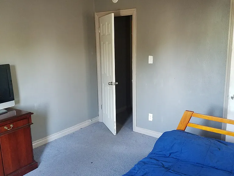 Front Bedroom has windows on 2 walls that brings in lots of light. The walls are newly painted white and floor are vinyl plank.