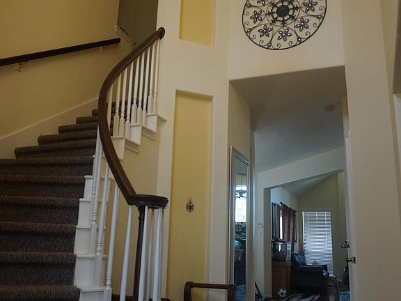 homey feeling two story grand foyer with a round staircase