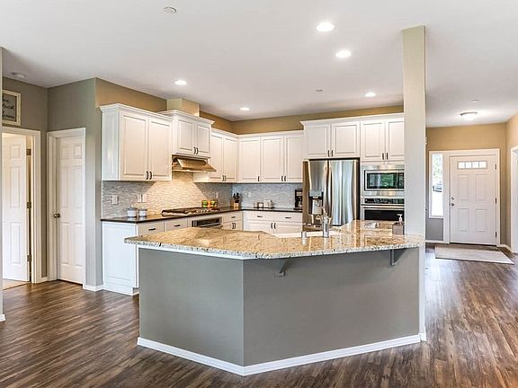 Gorgeous bright kitchen with island & eating bar.