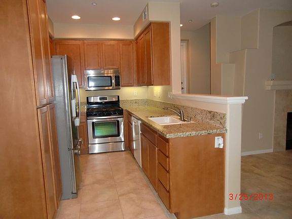 Kitchen has granite countertops, stainless steel ovens