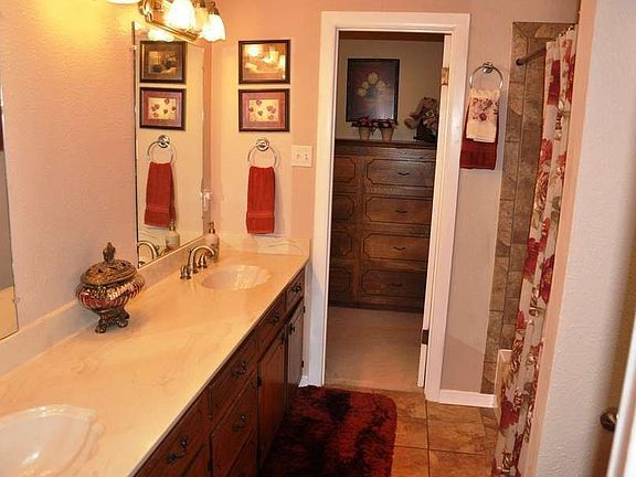"Updated master bath features double vanity with marble"