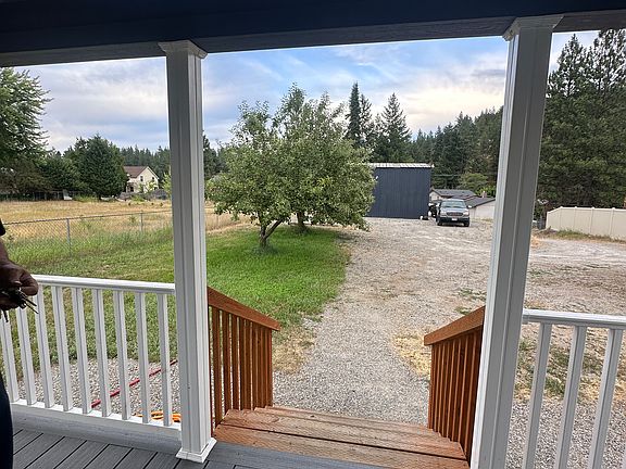 View out front door towards apple trees and shop.