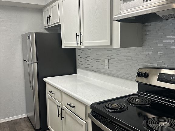 Galley Style Kitchen Featuring White Cabinetry