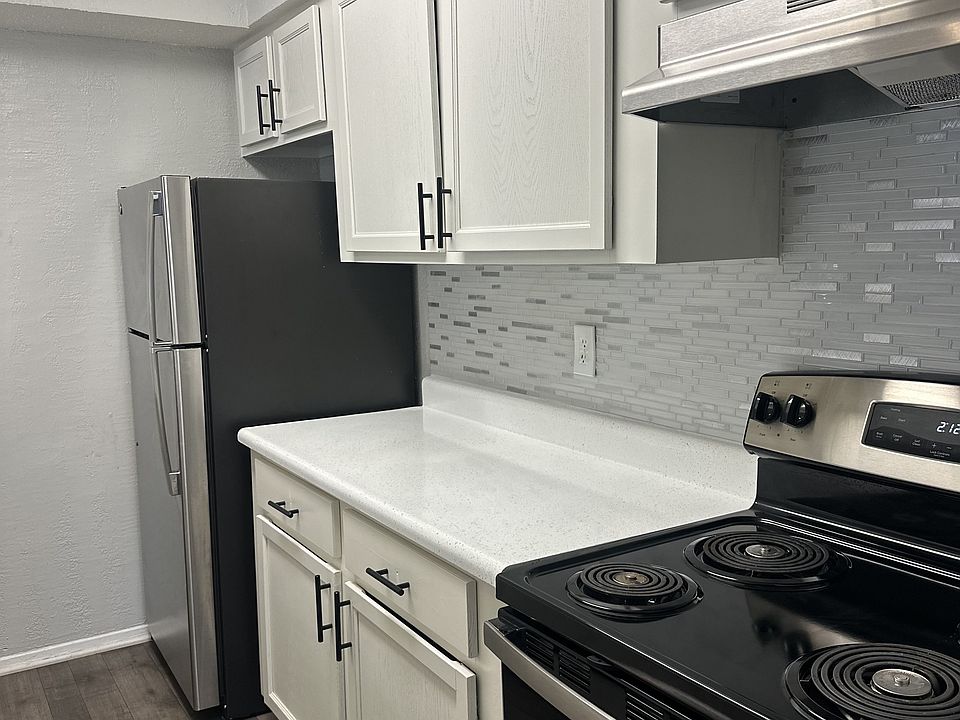 Galley Style Kitchen Featuring White Cabinetry