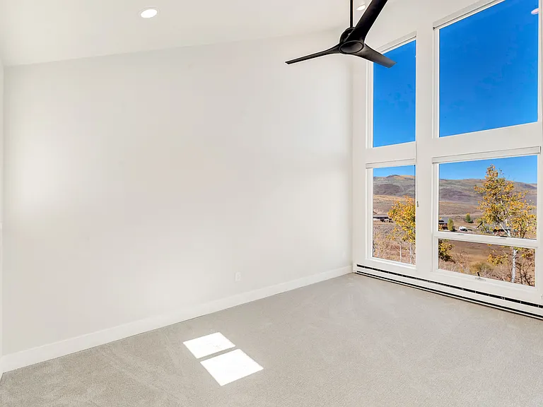 Bedroom #2 - on upper level. Floor to ceiling windows with electric black out window shades.