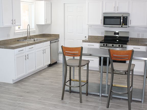 Kitchen with brand new appliances, new sink and faucet. Plenty of sunshine!