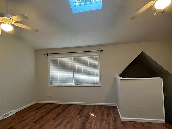 Living Room with skylight and ceiling fans