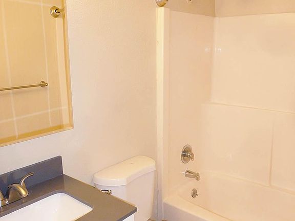 Full-Sized Tub with Shower, Stone-Top Vanity