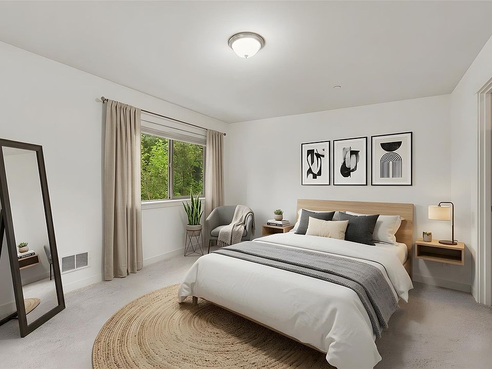 Spacious primary bedroom with natural light and a private ensuite bathroom.