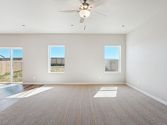 Spacious living room with a ceiling fan for game nights and watching your favorite shows.