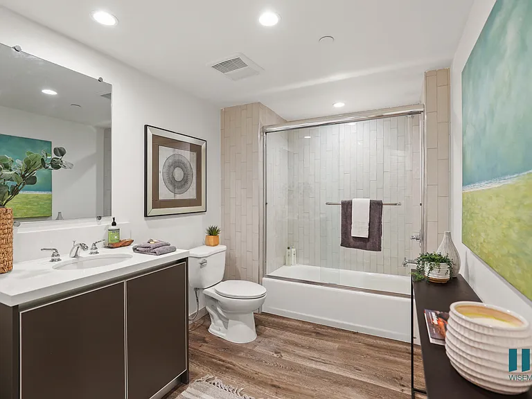 Large-Size Bathroom with Bathtub with Glass Door and Vanity Cabinet Storage