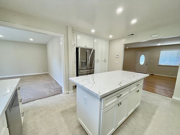 Kitchen with family room on the left and living/dining room on the right