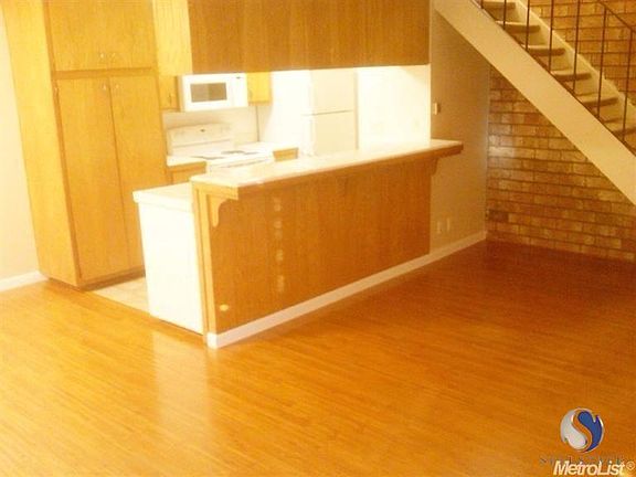 Large living area with wood floors.