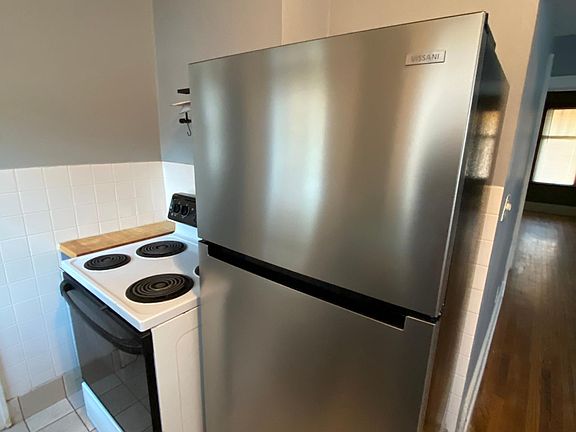 Kitchen with new stainless steel fridge