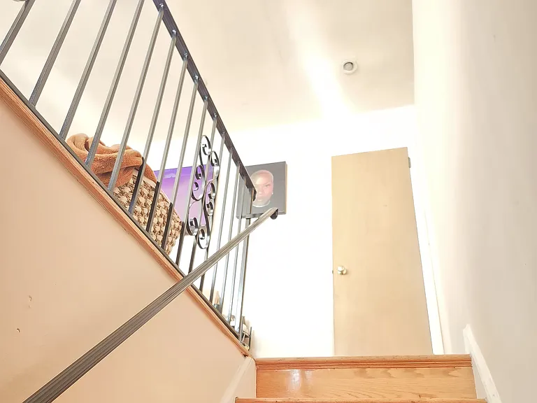 Sunlight approaching top of stairs (coat closet ahead)