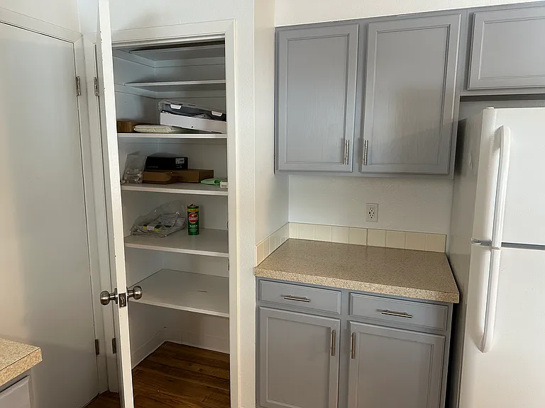Kitchen with Pantry next to garage door entrance.
