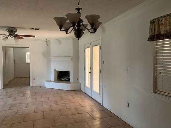 Looking from kitchen into dining room, living room, French doors to backyard. fireplace, and middle bedroom