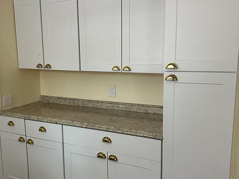 Additional cabinet storage in kitchen laundry area. Tall cabinets work great for pantry.