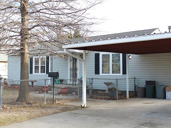 Nice carport provides shade and extra parking.