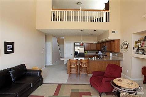 Open kitchen great room area with loft looking down from above.