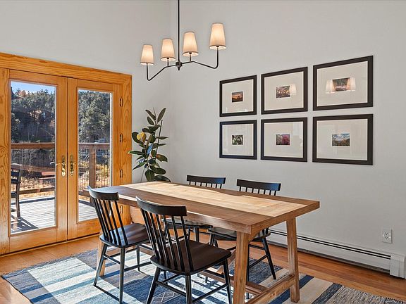 Dining area with new furniture and light fixtures, french door to deck space.