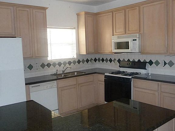 Large Updated kitchen, granite counters, tile floor, gas range,  refrigerator included, lots of counter space