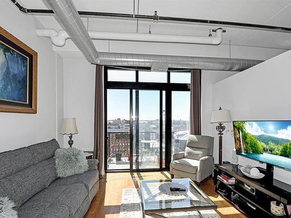 Open floorplan with living room/kitchen. Sliding doors to balcony