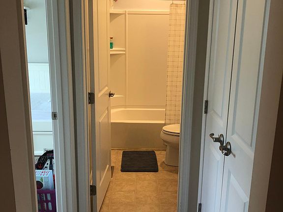 Small hall next to guest bad and bath with linen closet.