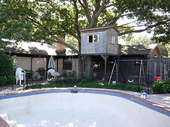 Back yard offering something for everyone - pool, treehouse, large patio area