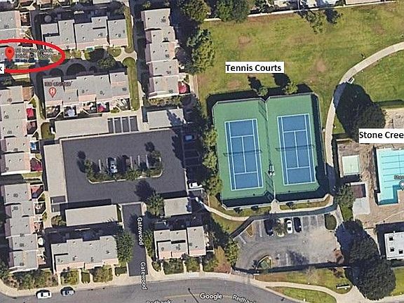 Aerial view of 50 Sparrowhawk townhome and the Stone Creek tennis and swimming center available for use.