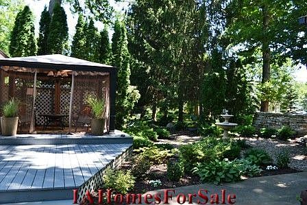 Deck Area. Outdoor lighting highlights the dry stacked stone wall as well as uplighting the oak tree