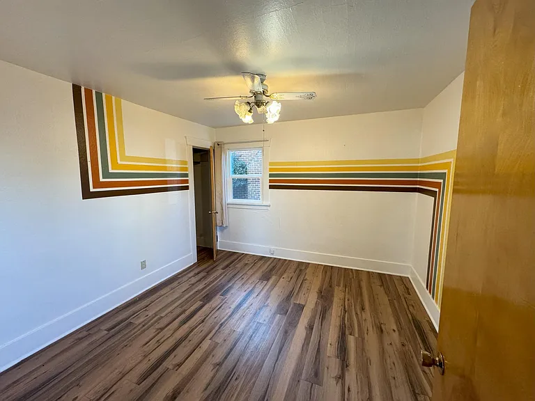 Bedroom 1 with hand painted 70's inspired mural