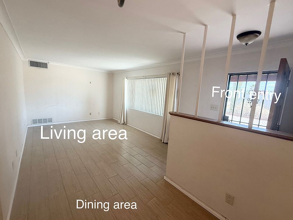 picture shows the living area, dining area and front door entry