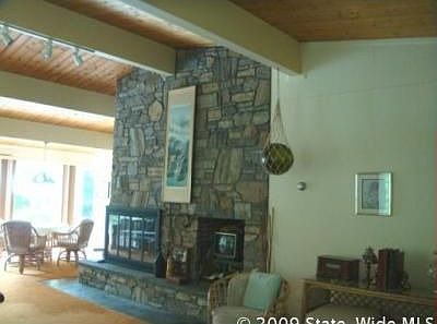 Great room 38 X 22 has floor to ceiling stone fireplace.