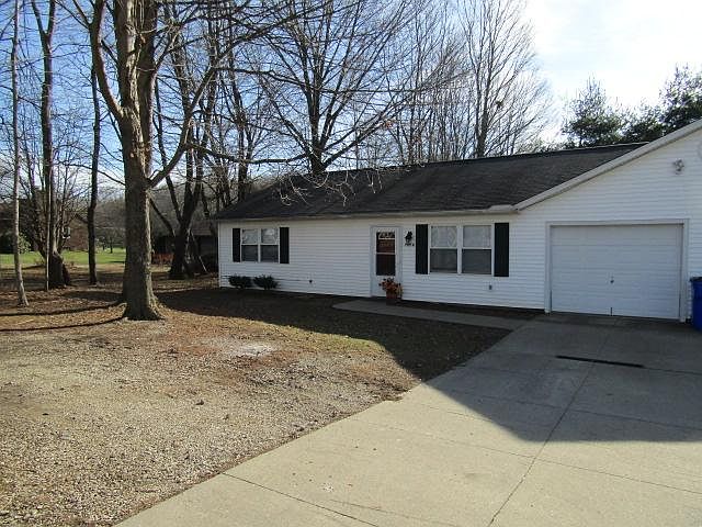 Twinplex on Tallmadge Road looks small on the outside but is surprising roomy inside! Gravel turn around between front yard trees.