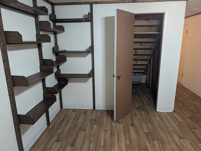 This house has a lot of storage spaces including under the stairs.
Built in bookshelves across from large desk