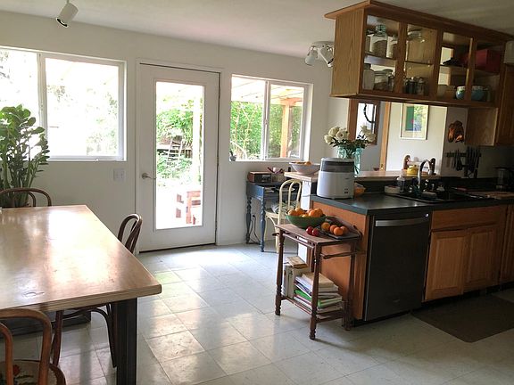Dining area and kitchen, view upon entering from living room. Back door opens onto a covered back deck. Can see entire garden from kitchen!
