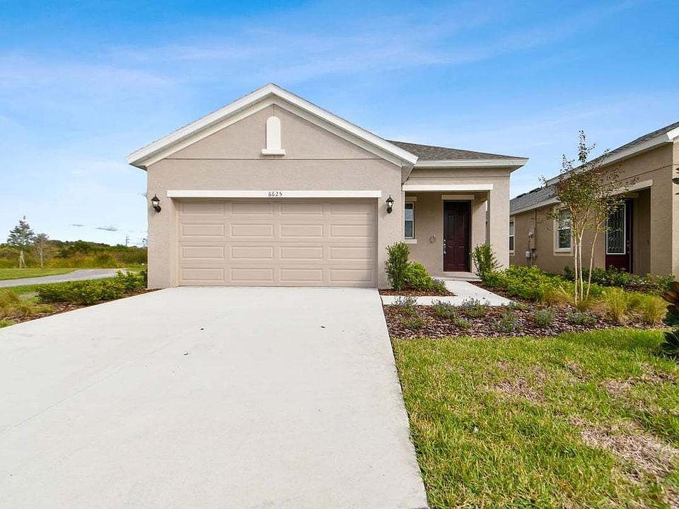 Flora new construction open concept plan tuscan elevation exterior at BridgeWater Lakeland, FL by Wi