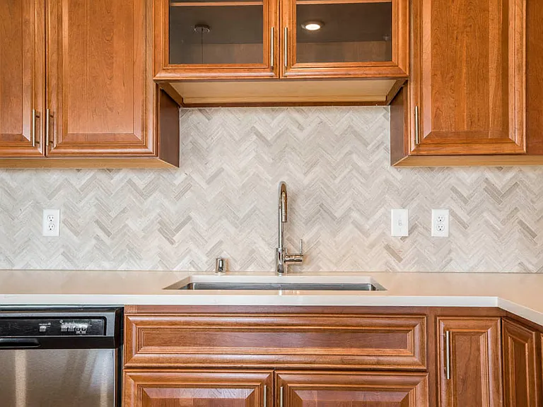 The Cognac premium package features a detailed herringbone backsplash in the kitchen.