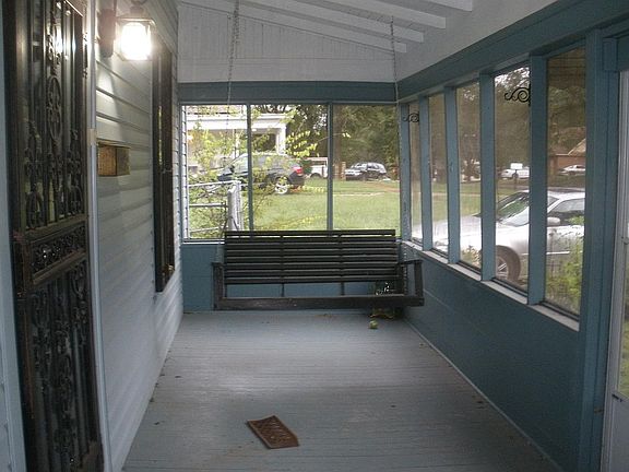 Screened-in front porch with swing