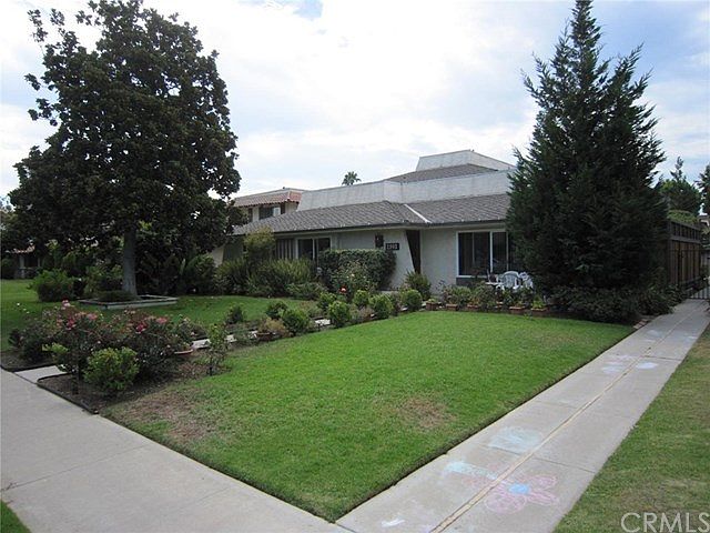 Front however the grass is green and the bushes are taller.