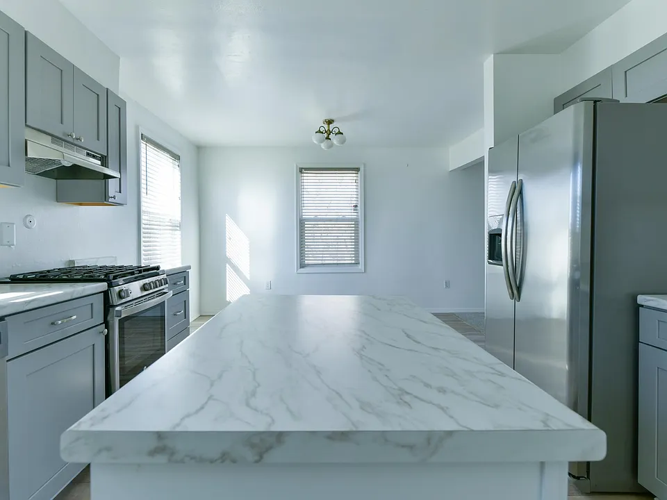 Kitchen with large island, upgraded counter tops and cabinets, and newer appliances