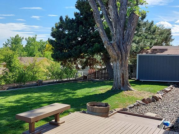 Backyard view of peaceful serenity. An area to put a grill attached to deck.